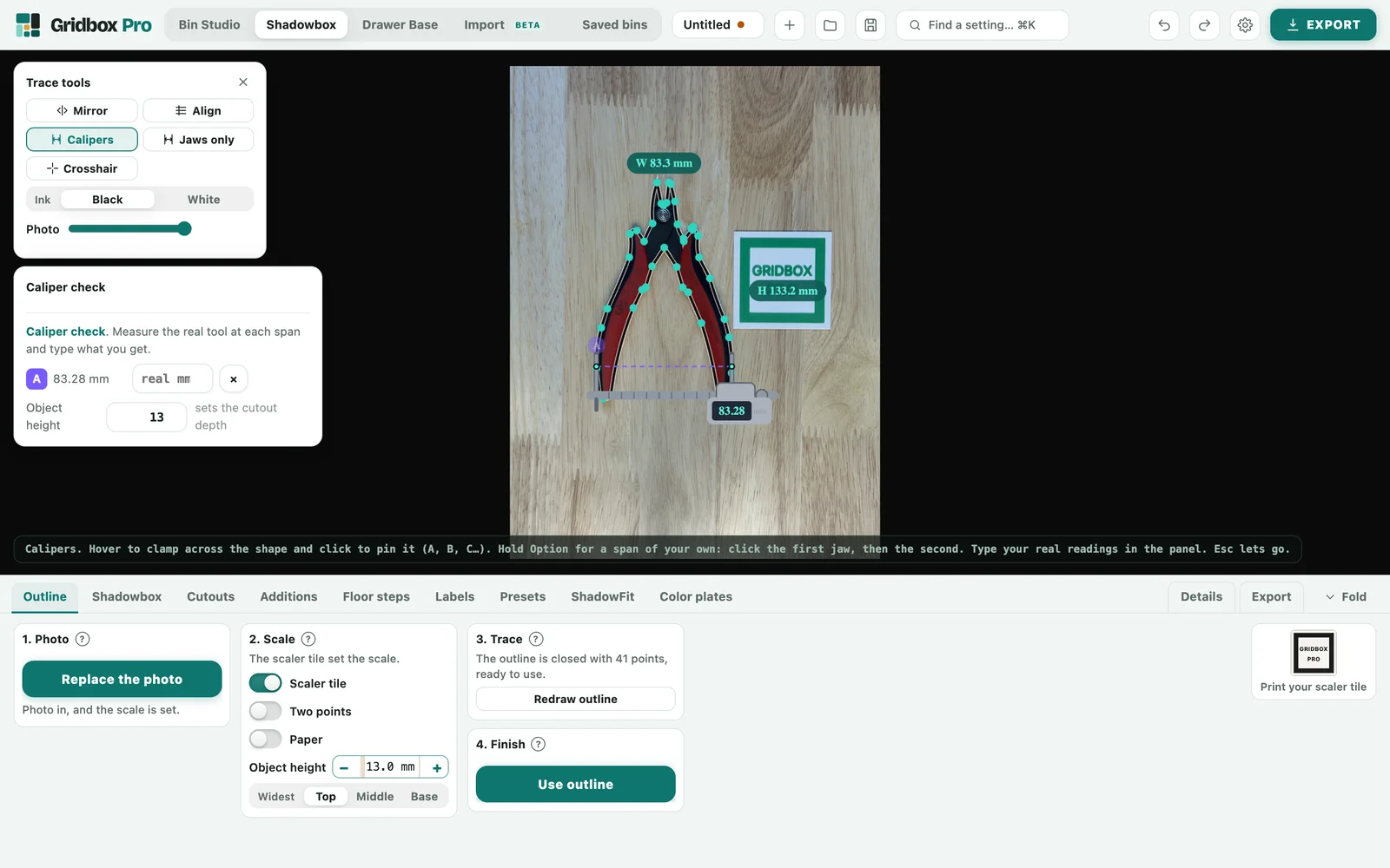Gridbox Pro tracing the wire cutters with Calipers on: span A across the handles reads 83.28 mm in the Caliper check card
